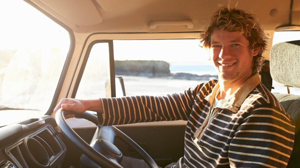 Smiling man driving motorhome